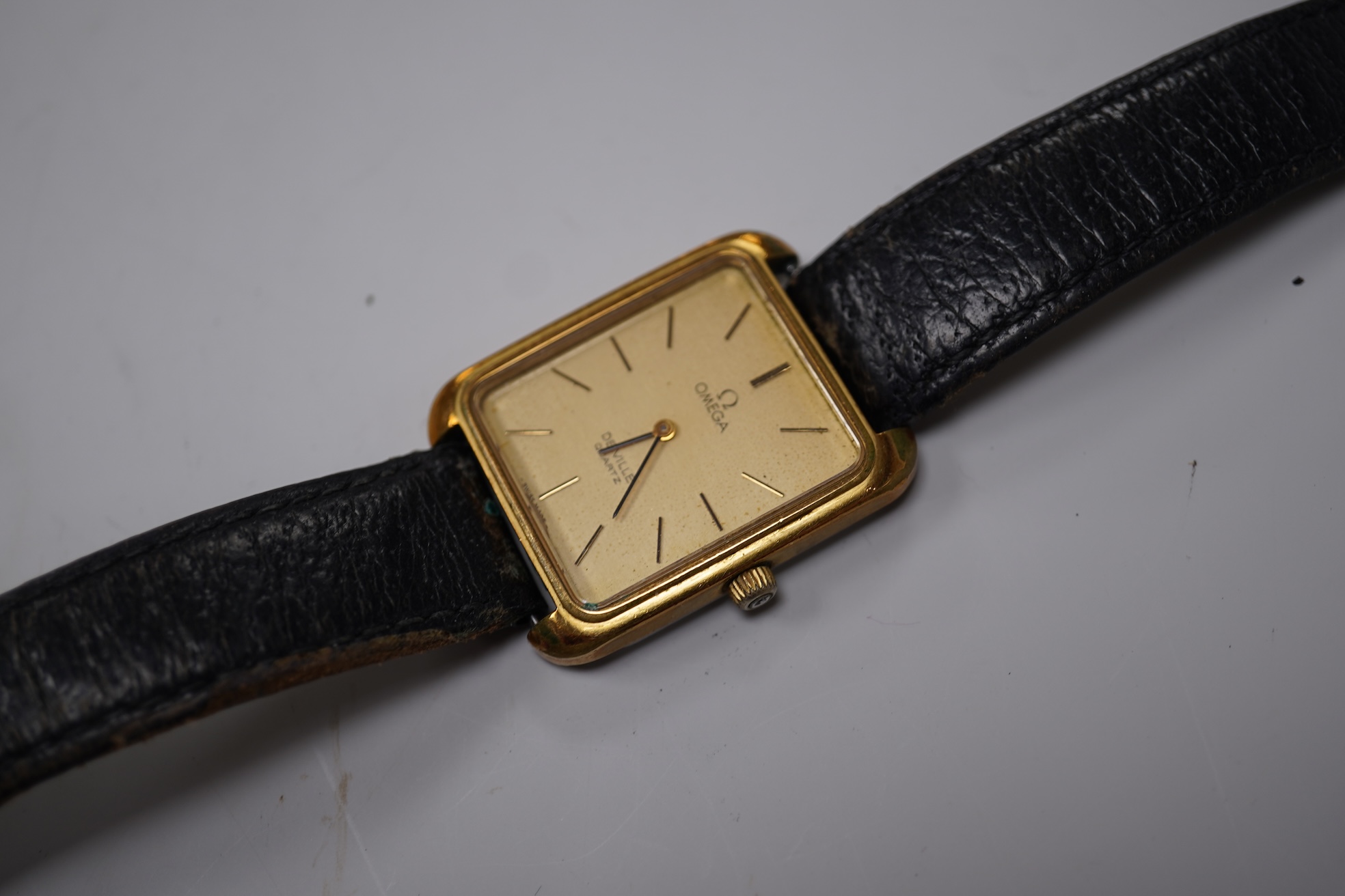 A gentleman's late 1970's steel and gold plated Omega De Ville quartz wrist watch, with rectangular dial and baton numerals, movement c.1330, case diameter 30mm, no buckle, box or papers.